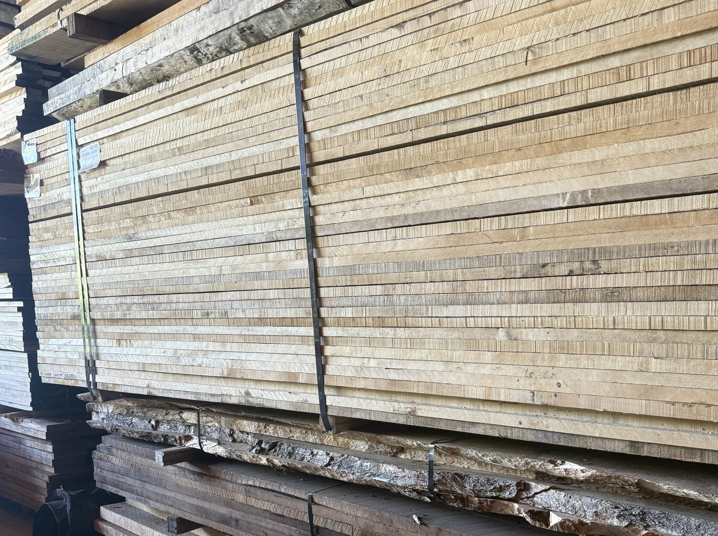 Bundles of kiln-dried hardwood stacked deep on the shop racks