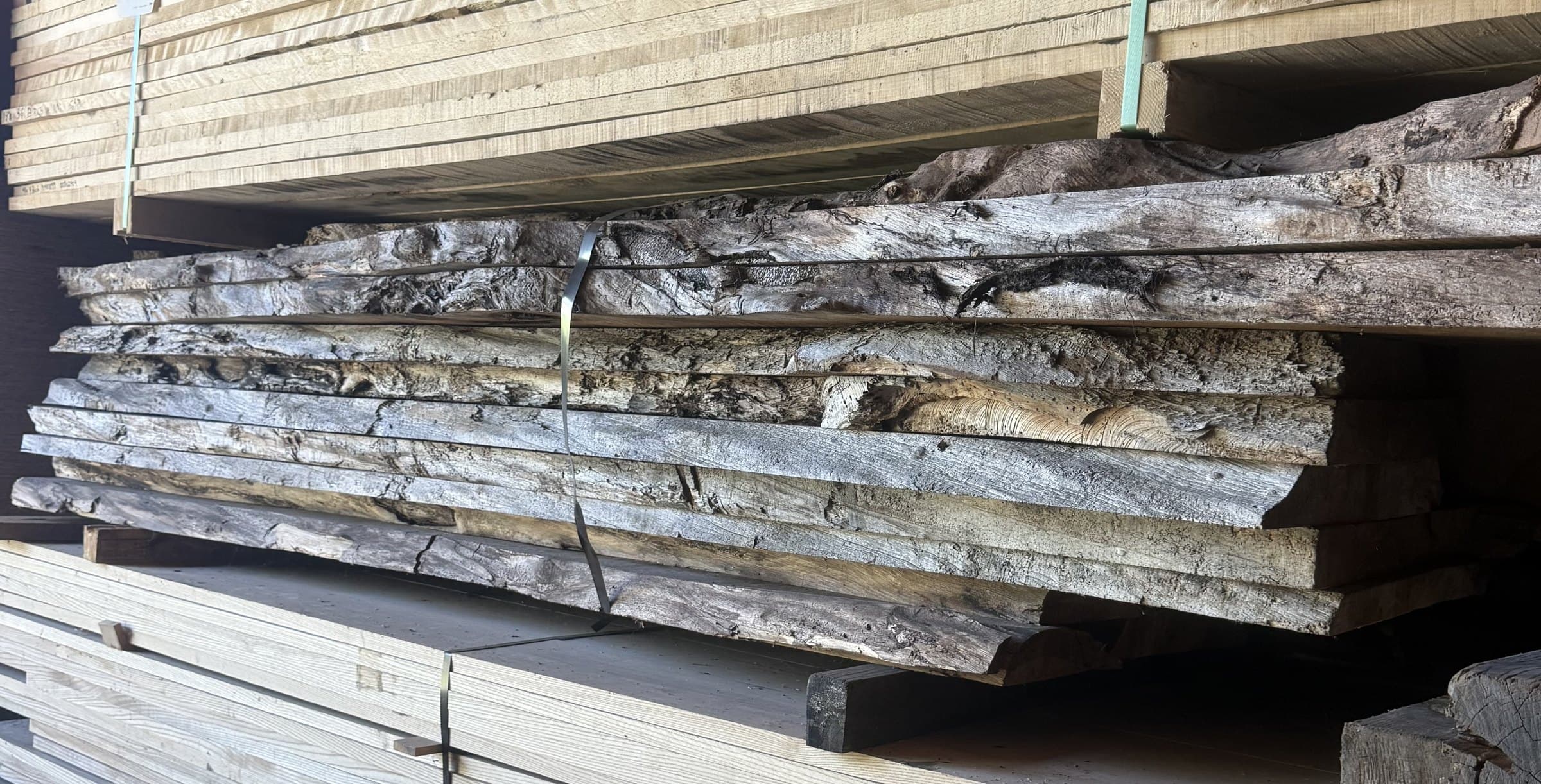 Live edge slabs stacked on the rack, bark edges out