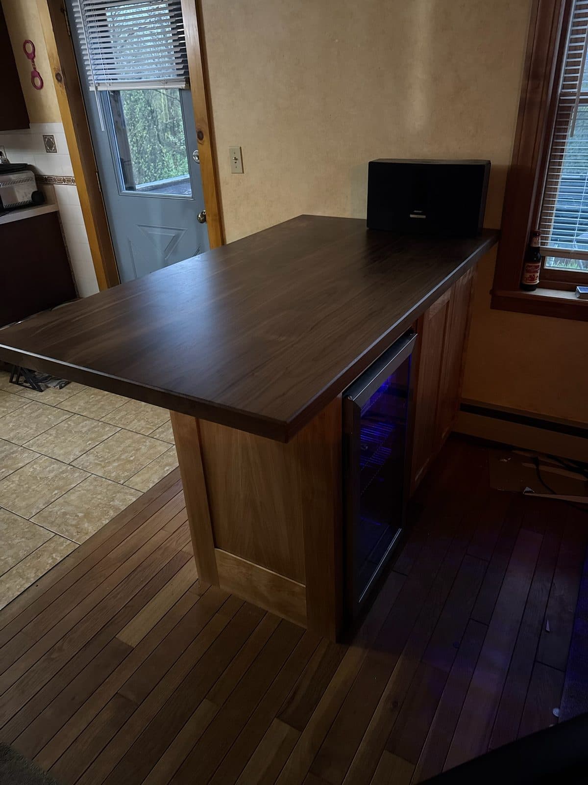 Bar island with a walnut top and beverage fridge