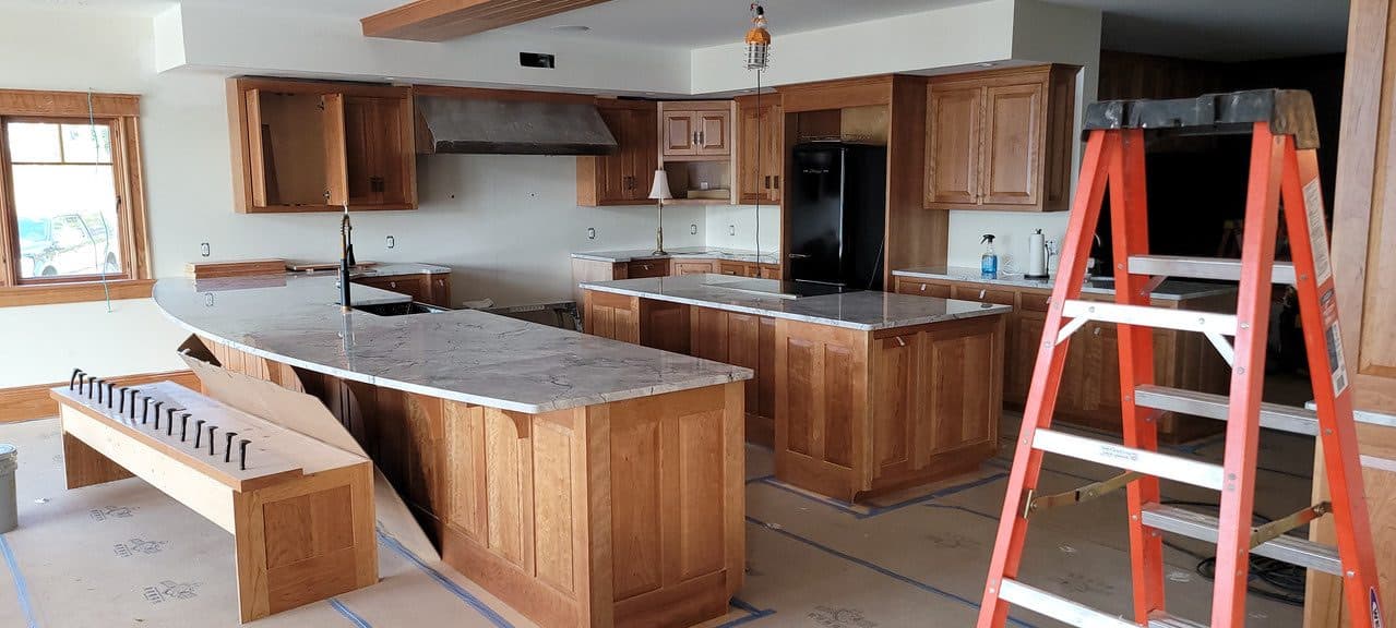 Cherry kitchen with a curved granite bar