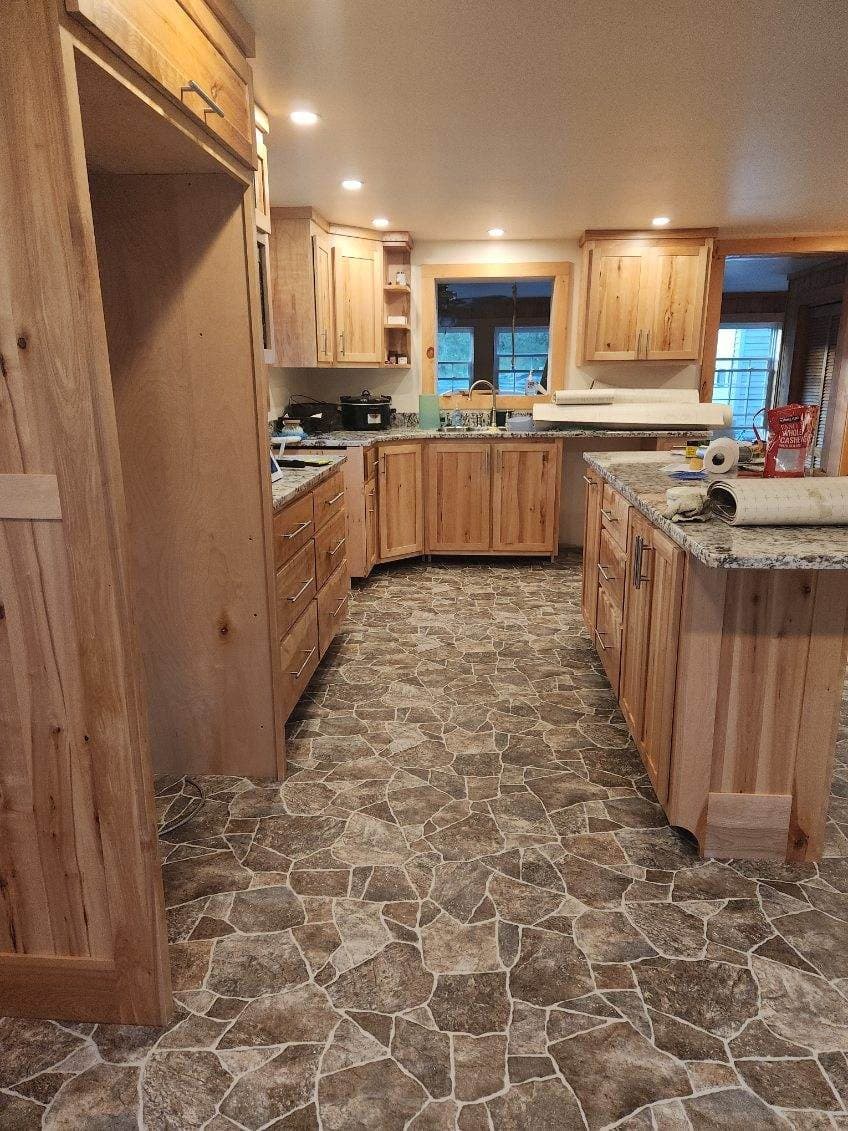 Hickory cabinetry over a stone floor