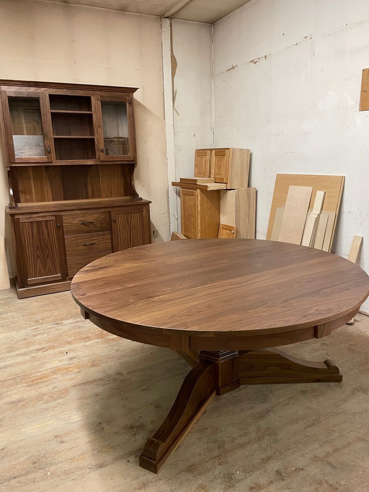 Walnut pedestal table with a matching hutch